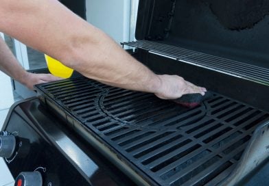 A man cleaning a grill